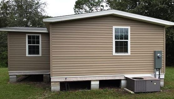 A house with two windows and a porch.