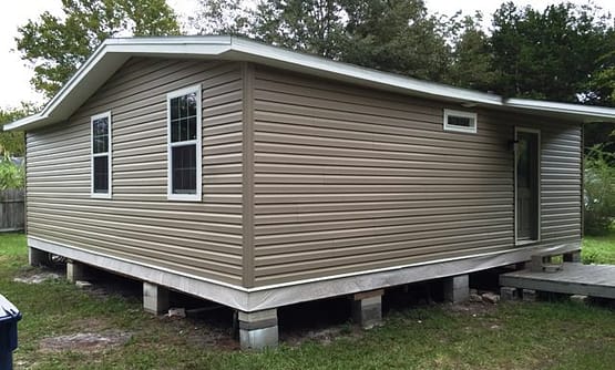 A small house with a lot of windows and a door.