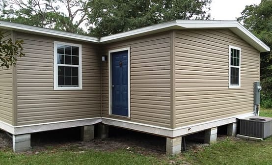A small house with a blue door and white trim.
