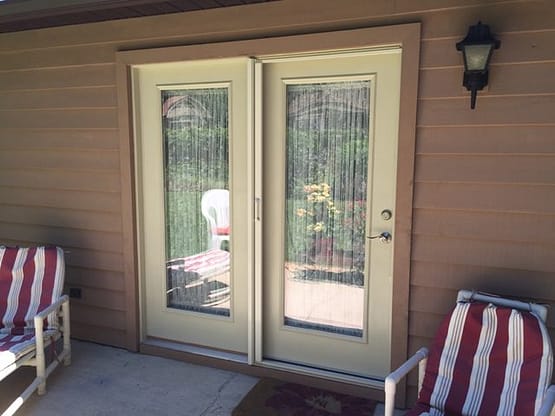 A patio door with two glass panels and one is open.