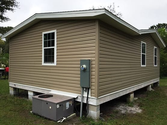 A house with a box sitting on the side of it.