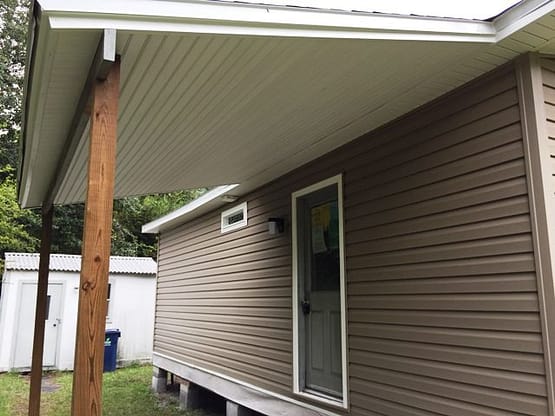 A house with a porch and door open.