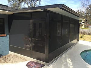 A black enclosed porch with a white floor.