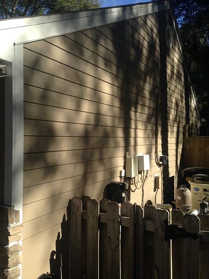 A wall with many trees and shadows on it