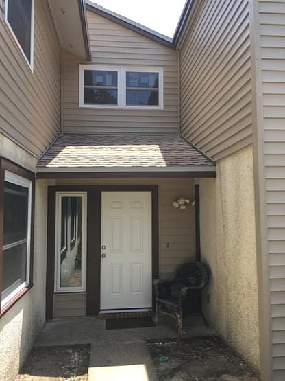 A door way with a window and a black bag