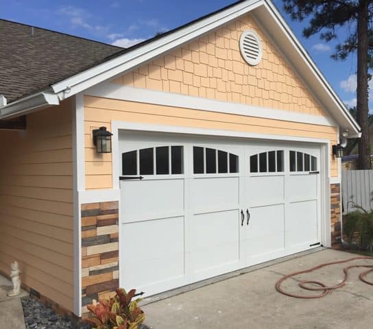 A garage door that is open and has windows.