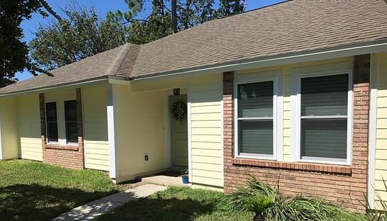 A house with a lot of bushes around it