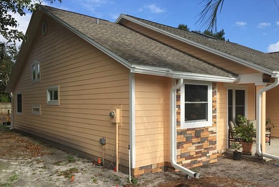 A house with a brick wall and window.