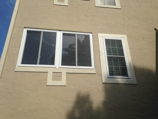 A building with two windows and one window is open.