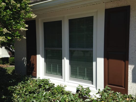 A white window with two windows in the middle of it.