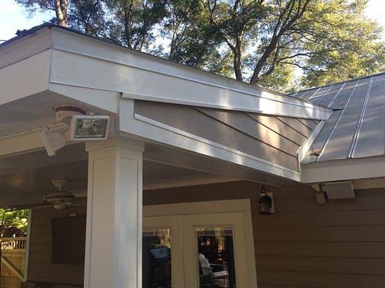 A porch with a white roof and a door.