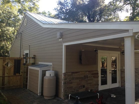A house with a large white door and two air conditioners.