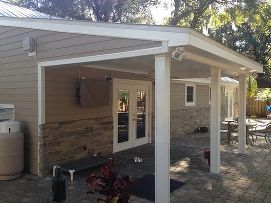 A patio with a bench and table in it.