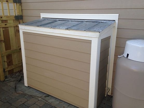 A small storage unit with a wooden lid.