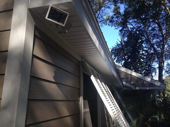 A house with a gutter and roof that is missing the vent.
