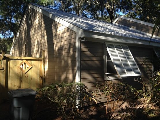 A small house with a large window in the middle of it.