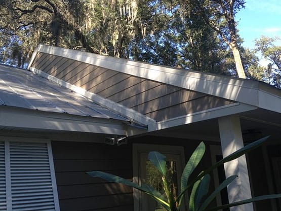 A house with a roof that has been painted white.