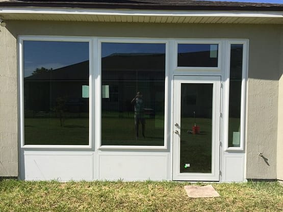 A white house with two windows and a door.