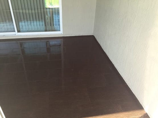 A room with dark brown tile on the floor.