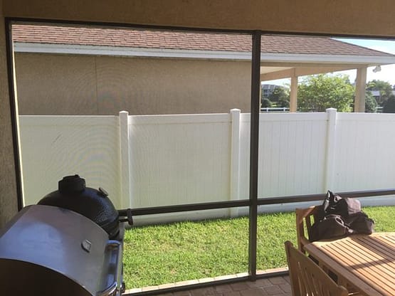 A view of a fenced in yard from outside.