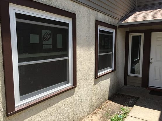 A house with two windows and a door.