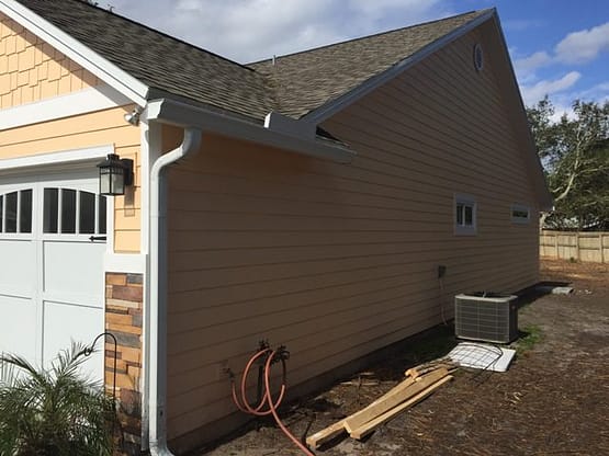 A house with a wooden fence and a building