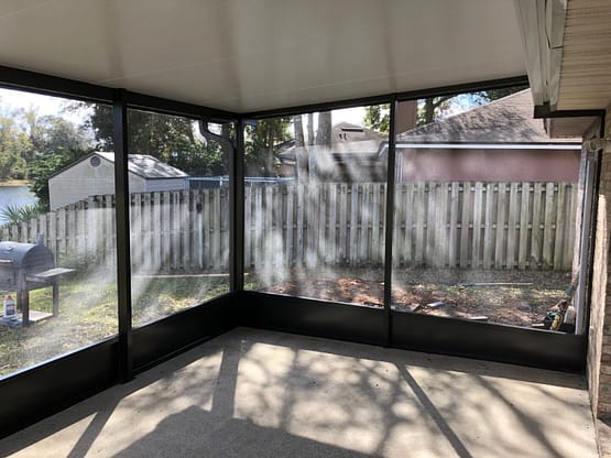 A room with a lot of windows and some fence