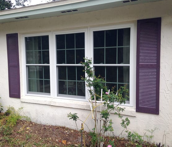 A house with purple shutters and windows.