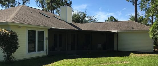 A house with a large lawn in front of it.