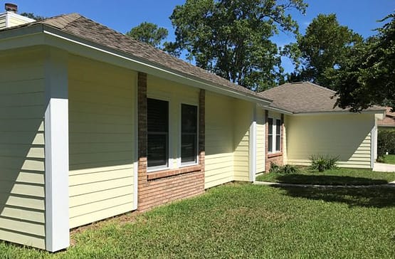 A house with a lot of windows and grass