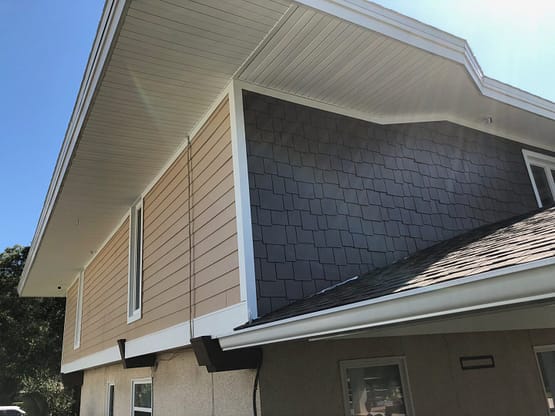 A house with a black roof and white walls