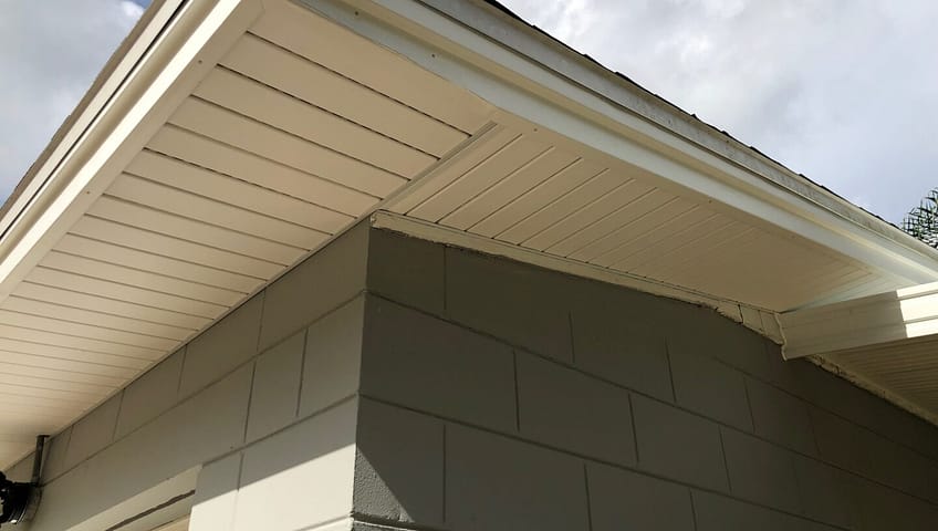 A house with a white roof and a sky background